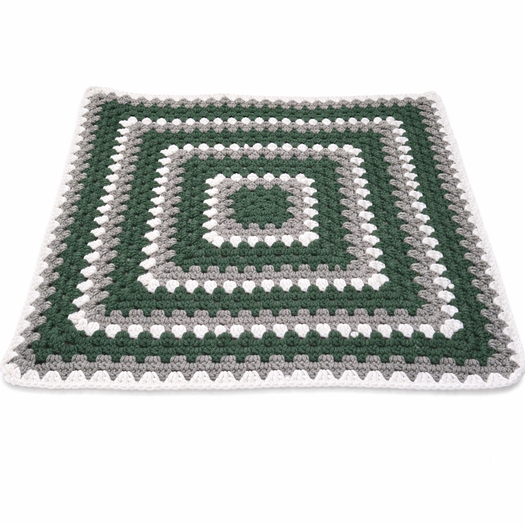 Handmade crochet green dinosaur blanket styled display | Unique Treasures