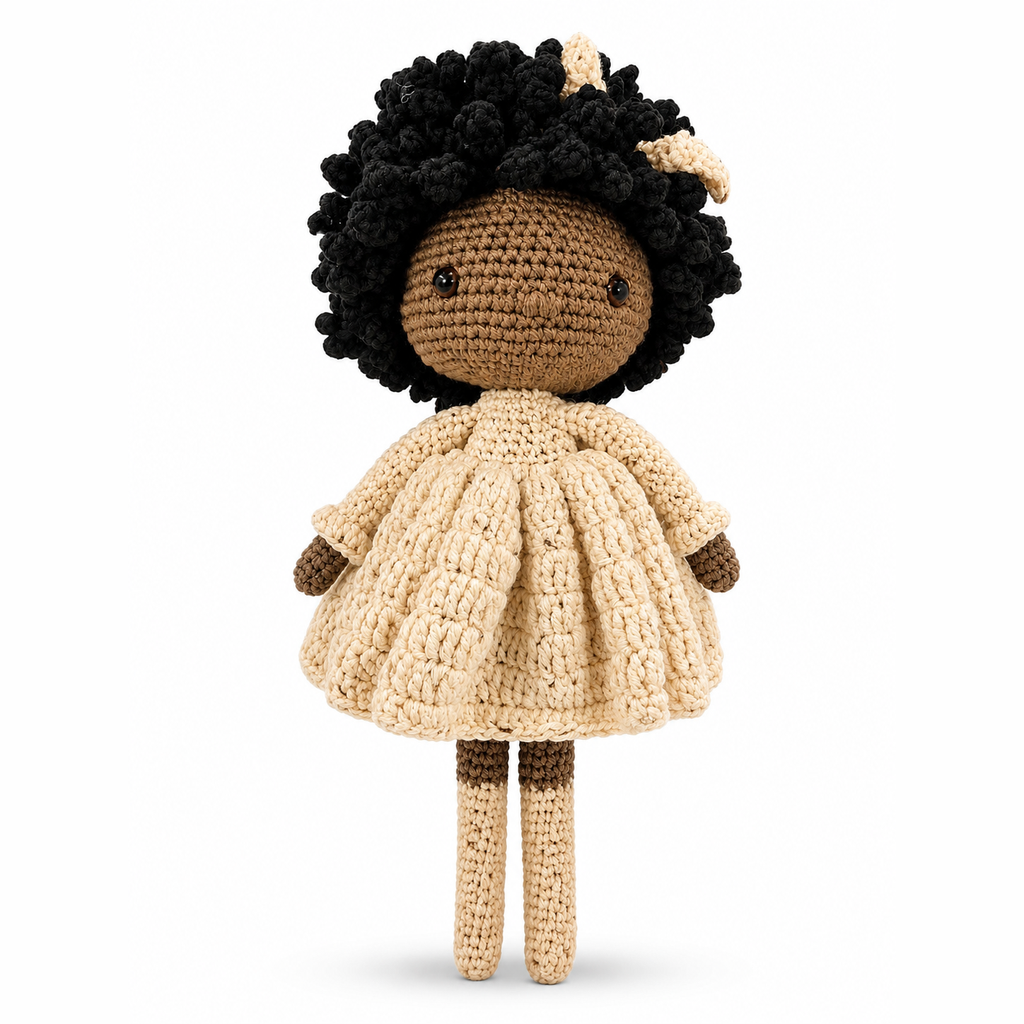 Crocheted doll with black hair and a beige dress on a white background